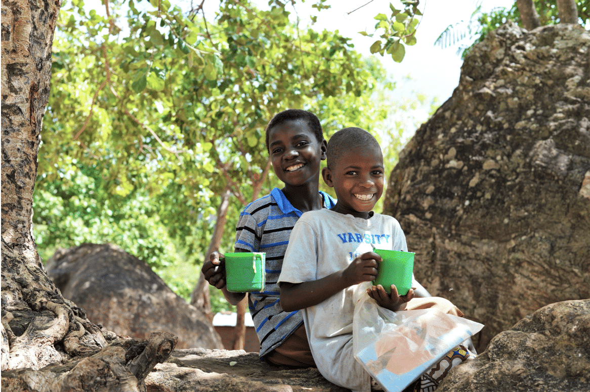 Children receiving their daily meal at Masuku primary school in Malawi through the Phala Project.